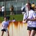 Pioneer No 1 doubles player Anna Borowicz runs to the net while playing with her partner on Tuesday, May 7. Daniel Brenner I AnnArbor.com